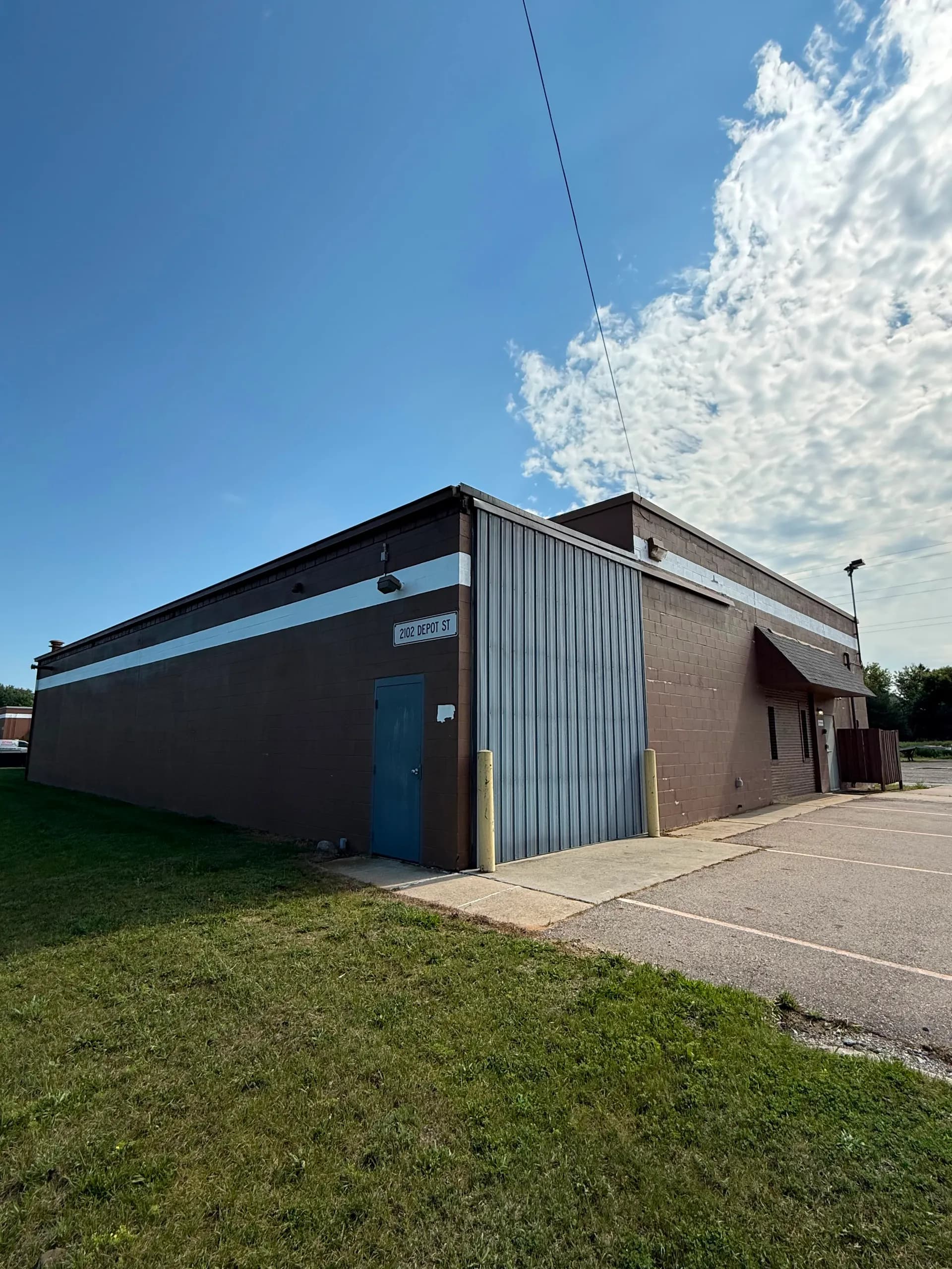Exterior of 2102 Depot St, a long open warehouse