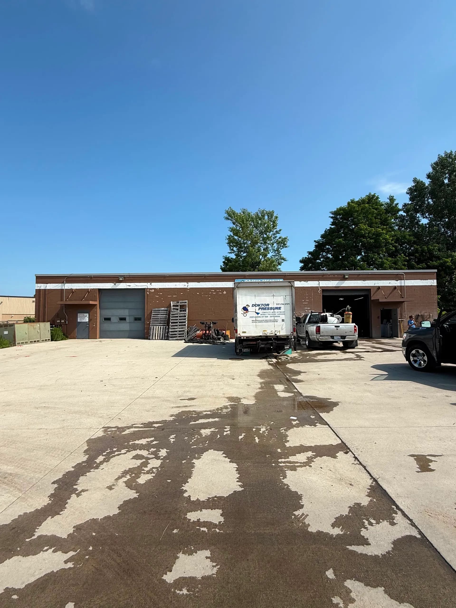 Exterior of 2114 Depot St, a shop with drive-in bays and a yard