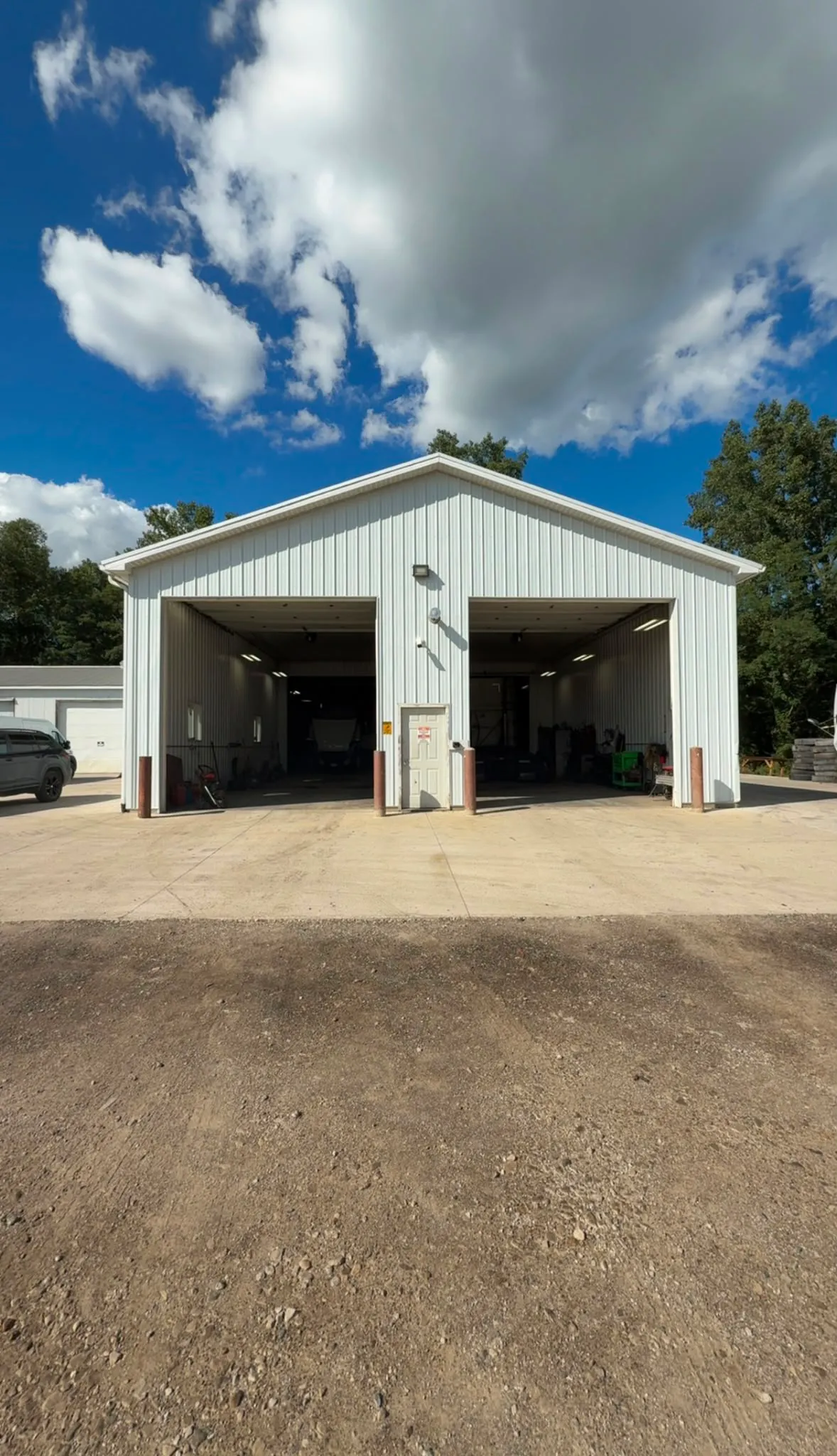 Building C Warehouse 1 at 4025 Holt Rd, a two-bay steel shop with its drive-in doors open