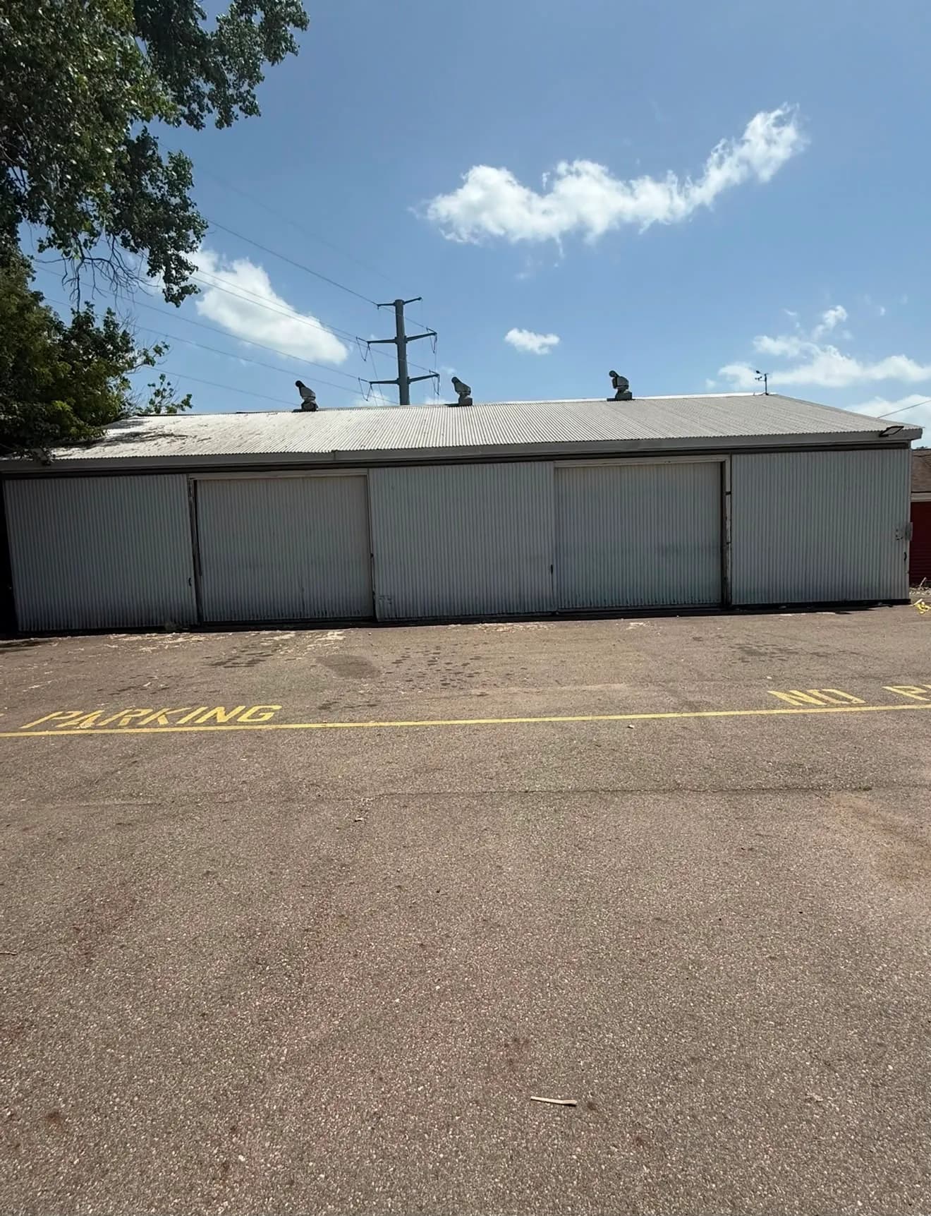 Warehouse 2 at 4025 Holt Rd, a row of sliding doors along the paved lot